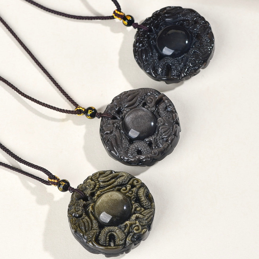 Obsidian double dragon guardian pendant, a feng shui dragon jewelry piece symbolizing power and protection