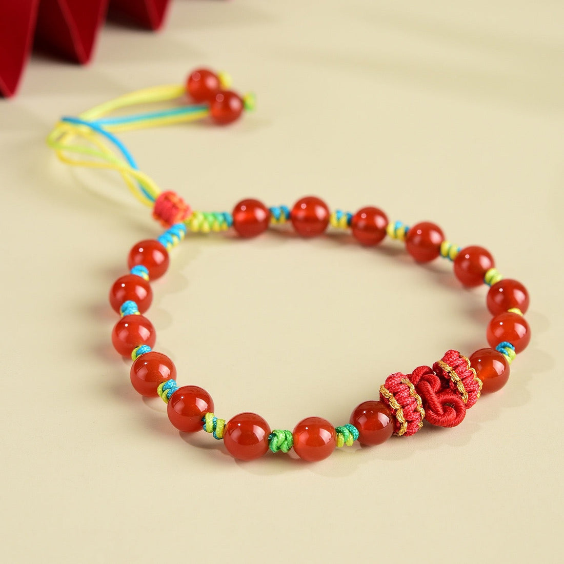 Red Agate Vitality Knot Bracelet with deep red agate beads and a hand-braided knot