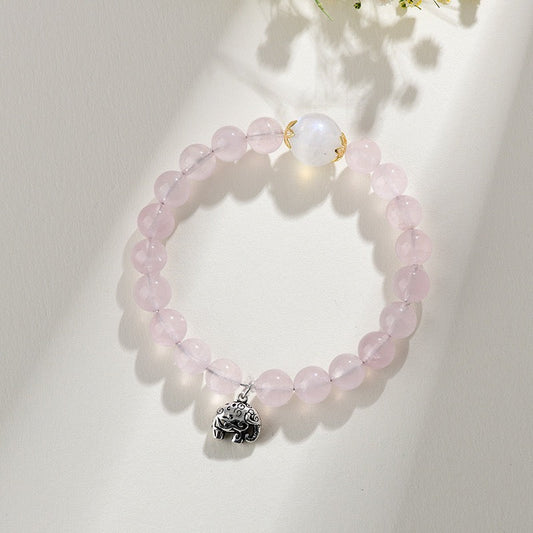 Rose quartz and moonstone beaded bracelet with a silver lucky elephant charm, showing moonstone's soft milky glow