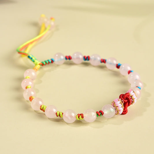 Rose quartz bracelet with soft pink beads and a handwoven wisdom knot