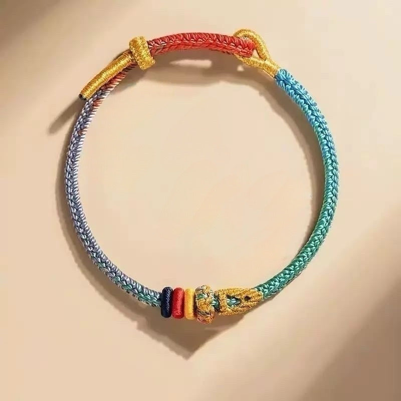 Seven Color Lucky Koi Bracelet with a koi fish charm on a hand-braided cord, a feng shui symbol of abundance and perseverance