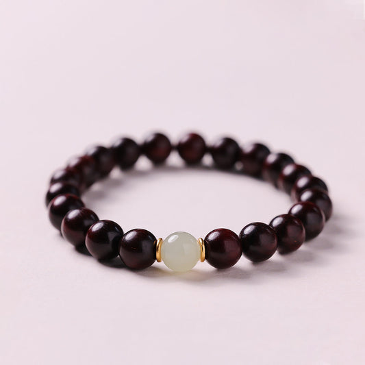 Small leaf red sandalwood bead bracelet with jade accent from Fortune & Karma